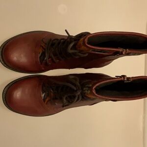 These boots are a size six. They are red with a foot and plush interior